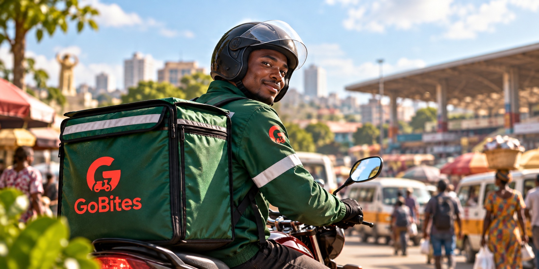 GoBites delivery rider on a motorcycle in a busy Kumasi market district
